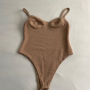 tan body suit, corset looking